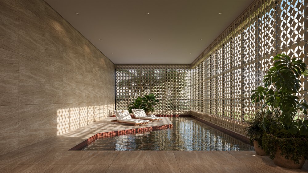 Piscina coberta com espreguiçadeiras e fachada de cobogós