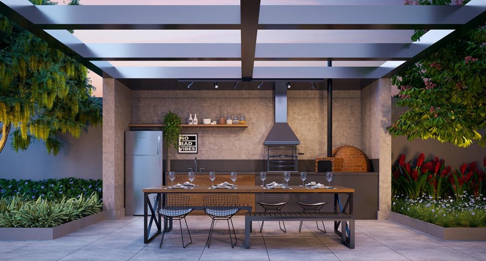 Churrasqueira do espaço gourmet com forno de pizza, pergolado e mesa de jantar