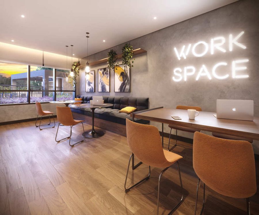 Coworking com mesas compartilhadas e letreiro neon na parede